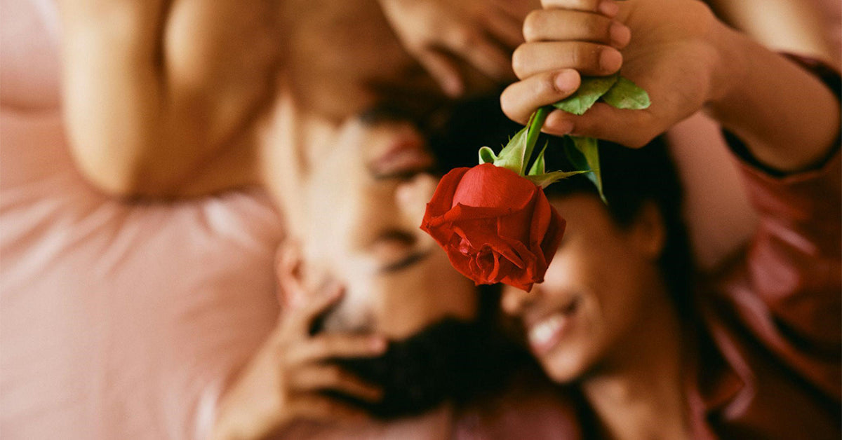A happy couple lying in bed together